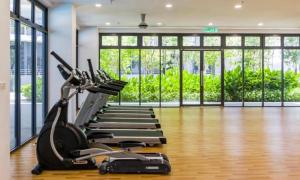 a gym with a treadmill and elliptical machines at Core SoHo Luxury Suite KLIA Airport in Sepang