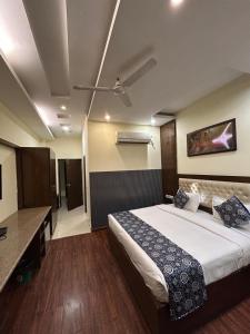 a hotel room with a bed and a desk at Hotel sun park inn in Dehradun