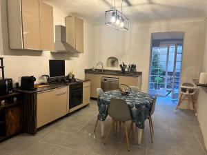 a kitchen with a table and a dining room at Appartement Citadelle in Bonifacio