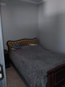 a bedroom with a bed with a blue blanket at Hostel Dilijan in Dilijan