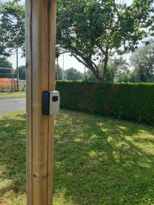 a light on a wooden pole in the grass at Camping Onlycamp Les Grenettes in La Varenne