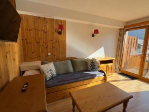 a living room with a couch and a table at Les Orres 1800 - 6 pers - Piscine in Les Orres