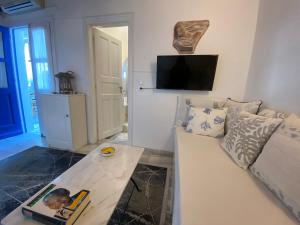 a living room with a couch and a table at Samanti Mykonos Sea View in Agios Ioannis Mykonos +27 photos