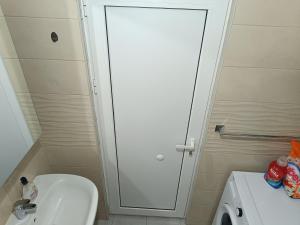 a bathroom with a white toilet and a sink at Viewpoint house in Donja Jošica +5 photos