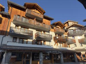 a building with balconies on the side of it at Les Orres 1800 - 6 pers - Piscine in Les Orres