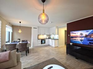 a living room with a kitchen and a dining room at Modern brand new apartment Kongsberg in Kongsberg