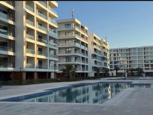 an apartment complex with a swimming pool in front of a building at RM Apartment Sea Breeze in Baku
