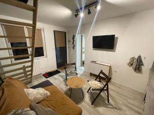 a living room with a couch and a table at Mazot en Abondance in Vacheresse