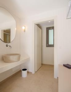 a bathroom with a sink and a mirror at FarOut - BeachResort & Camping in Mylopotas