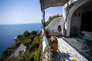 a view of the ocean from a house balcony at Villetta La Conca in Conca dei Marini
