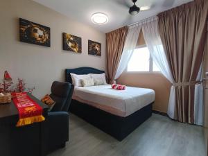 a bedroom with a bed and a chair and a window at YNWA Shankly Stay, Near KLIA in Sepang +30 photos