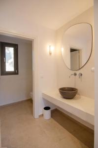 a bathroom with a bowl sink and a mirror at FarOut - BeachResort & Camping in Mylopotas