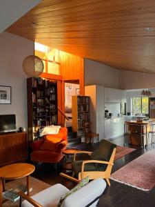 a living room filled with furniture and a kitchen at Queens Drive in Oneroa