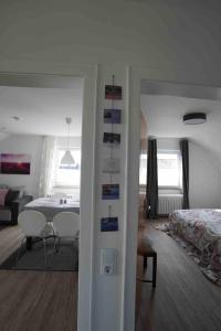 a room with a bed and a room with a table at Bella Casa am Rhein in Bad Honnef am Rhein +17 photos