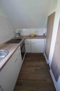 a small kitchen with a sink and a counter at Bella Casa am Rhein in Bad Honnef am Rhein