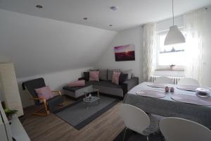 a living room with a couch and a table at Bella Casa am Rhein in Bad Honnef am Rhein