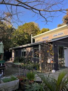 a house with a garden in front of it at Queens Drive in Oneroa +25 photos