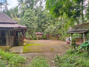 a garden with a house and a pavilion at Villa Ndelik Ijen in Kalibendo