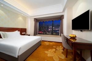 TV a/nebo společenská místnost v ubytování Xinghui Hotel