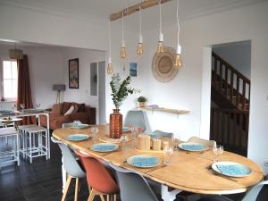 a wooden table with chairs and a dining room at L'échappée Belle - La Grande Tribu in Rhinau