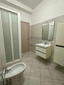 a bathroom with a sink and a toilet and a mirror at DonnaPeppina Siracusa in Plemmirio +13 photos