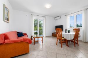 a living room with a couch and a table at Apartments Bogović in Malinska