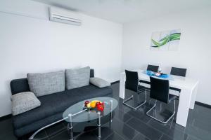 a living room with a couch and a table at Apartments Ilak in Trogir