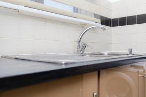 a kitchen counter with a sink in a kitchen at POLO HEIGHTS-Sky Suites in Accra +48 photos