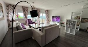 a living room with a couch and a table at Villa Dalia in Gračanica