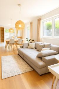 a living room with a couch and a table at RuheTraum 80 - Design-Apartment in Bruckberg