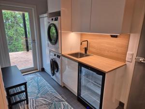 a kitchen with a sink and a washing machine at Huippumökki Himos in Jämsä +5 photos