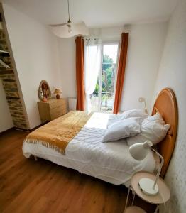 Postel nebo postele na pokoji v ubytování La Basque - un balcon au coeur de La Gacilly + 12 fotografií