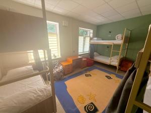 a room with two bunk beds and a carpet at Хостел Vibe Place in Dnipro +6 photos