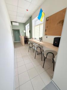 a room with a table and chairs in a kitchen at Хостел Vibe Place in Dnipro