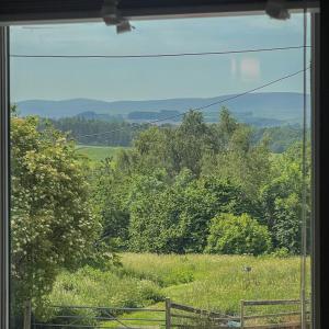 a view of a field from a window at Helvellyn Cottage in Penrith +27 photos