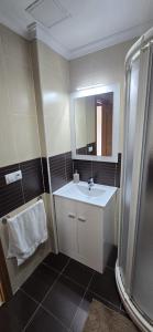 a bathroom with a sink and a mirror and a shower at Ático Paraíso in San Ciprián