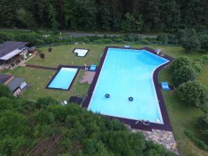 an overhead view of a large swimming pool in a yard at Waldhaus Deluxe in Zorge in Walkenried