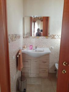 a bathroom with a sink and a mirror at Casa Elisa in Flumini di Quartu