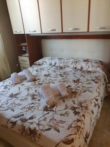 a bedroom with a bed with towels on it at Casa Elisa in Flumini di Quartu