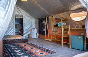 a room with a tent with a bed and a rug at Life's A Beach in Quy Nhon