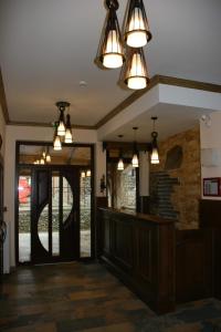 a lobby with pendant lights and a cash register at Pensiunea Valceaua Zanelor in Drăguş