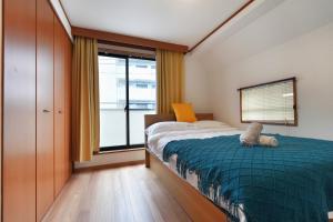 Postel nebo postele na pokoji v ubytování Tokyo Tsuruga Villaー東京雅鶴