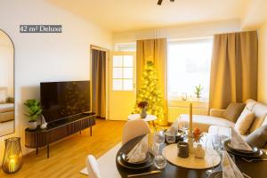 un soggiorno con un albero di Natale alla finestra di Adorable Arctic Apartments - Private Sauna & Free Parking a Rovaniemi
