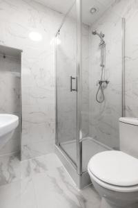 a bathroom with a shower and a toilet and a sink at Nestio - Paddington Serviced Studios! in London