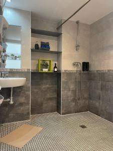 a bathroom with a sink and a shower at Ático Fuengirola Playa Centro Ciudad in Fuengirola +25 photos