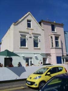 a yellow car parked in front of a building at The Ship Inn - Sandgate in Folkestone