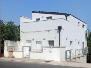 a white building on the side of a street at Charming studio apartment with parquet in Altamura