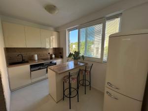 a kitchen with a refrigerator and a table and chairs at Apartment Rita in Makarska
