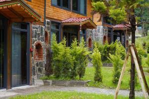 a house with a bunch of plants in front of it at River Villas Resort in Çamlıhemşin