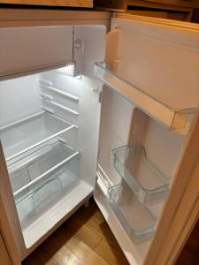 a white refrigerator with its door open with its at Bodza Vendégház in Balatonfüred